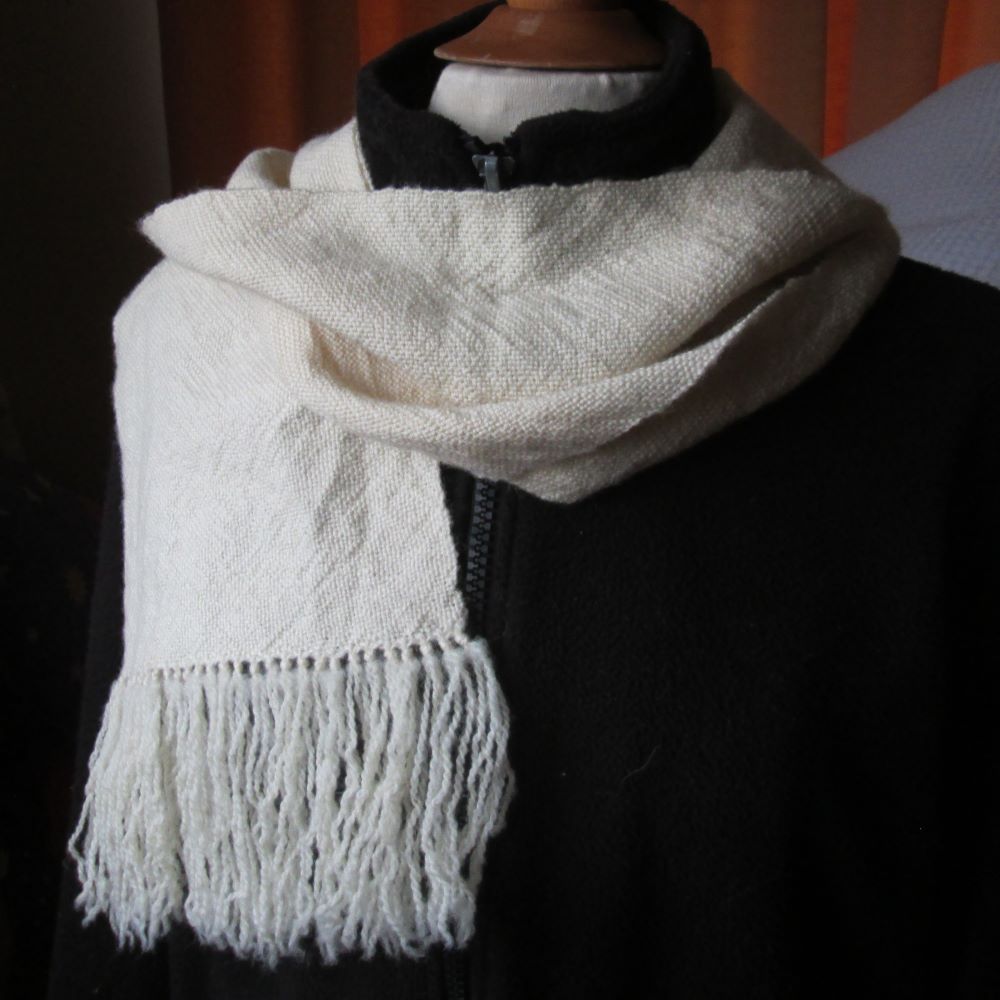 Natural cream scarf on a mannequin with black jacket