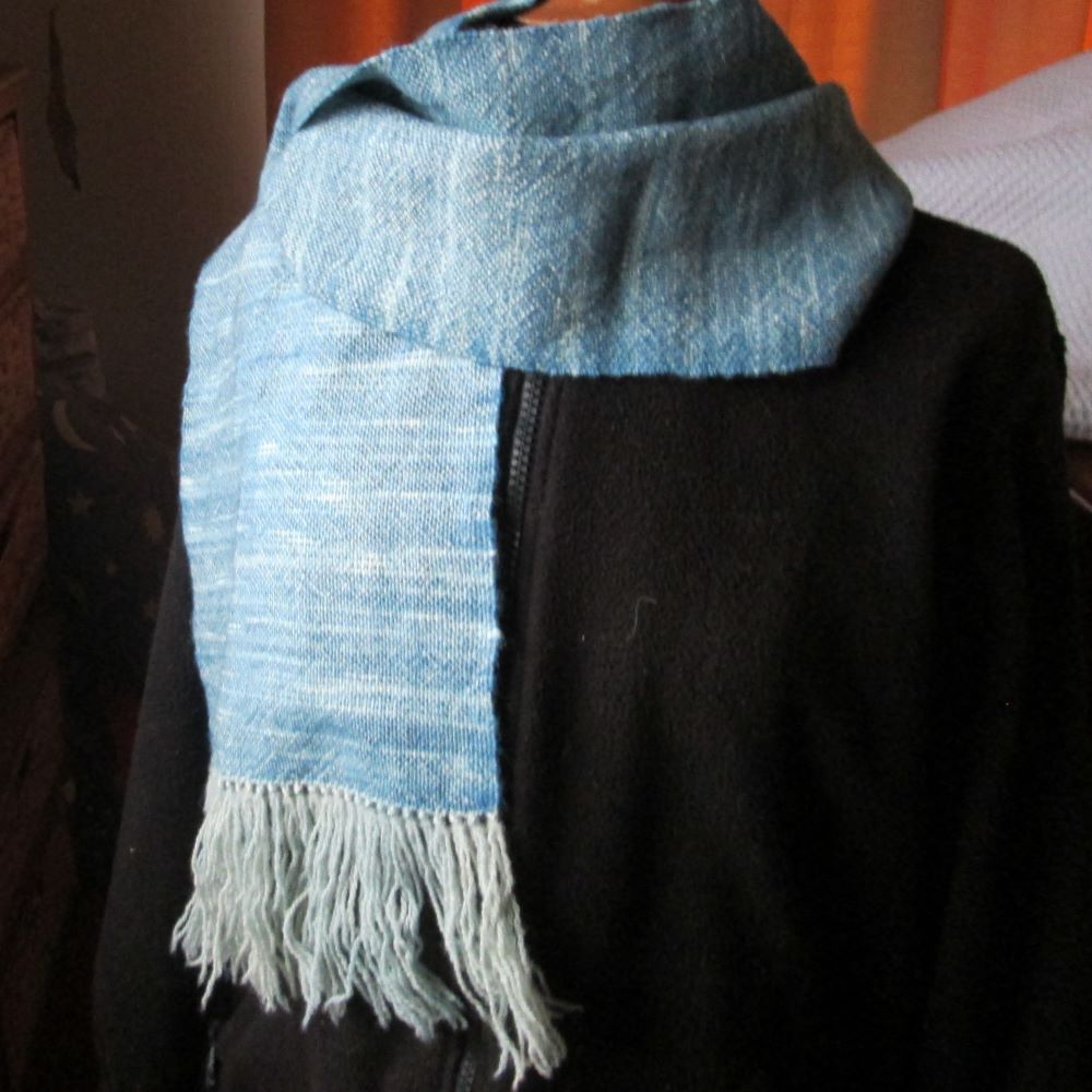 dark blue and cream checked scarf on a black bakgroun