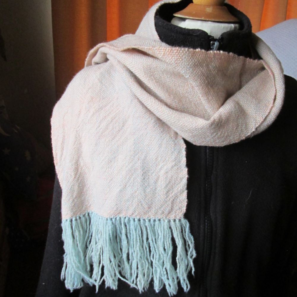 pink and blue taffeta scarf on a mannequin wearing a black jacket