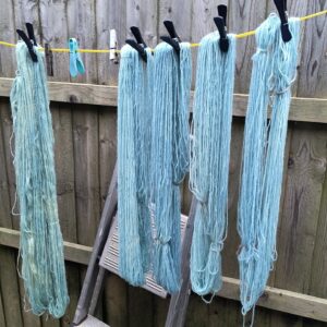 Blue yarn against a wooden fence
