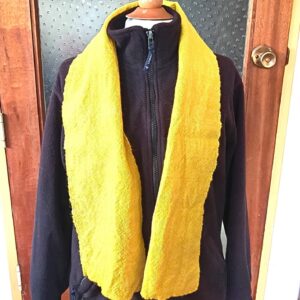 Yellow scarf on a black coat on mannekin