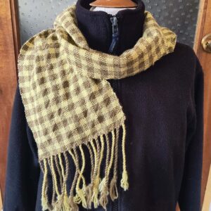 yellow and green checked scarf on a mannekin with a black jacket